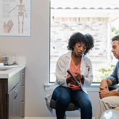 Doctor And Patient In Exam Room