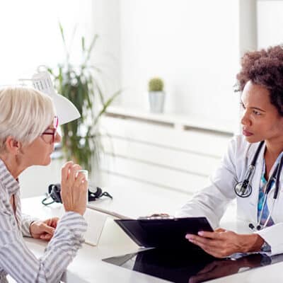 Doctor And Patient Reviewing Chart