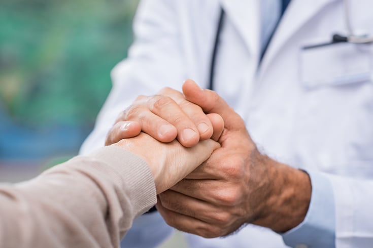 Doctor Holding Patient's Hand