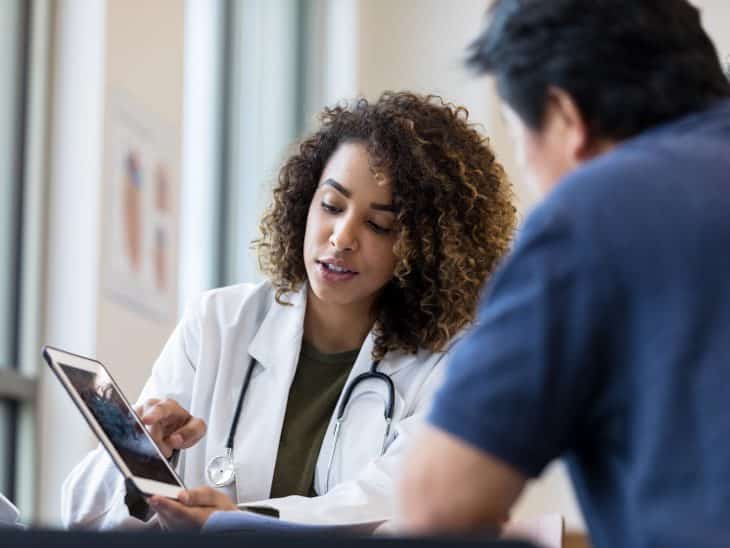 Doctor Reviewing Readings on Tablet with Patient