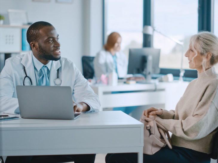 Doctor With Patient At Desk ISt1355655584 730x548