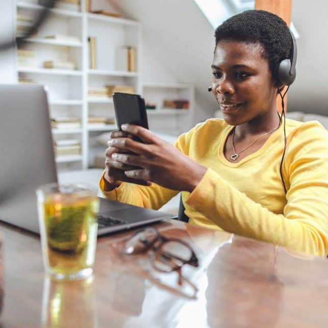 Girl with Headphones Checking Readings on Her Phone