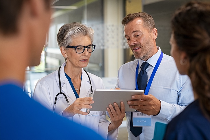 Doctor Reviewing RPM Dashboard With Specialist